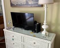 54"W x 30"H x 17"D white wicker dresser with glass top; some signs of wear but could easily be repainted. $125