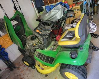 John Deere riding mower with hitch to pull the Cyclone Rake XL with trailer