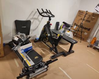 Exercise equipment, some new in box. Under desk Treadmill, stationary bike, Total Gym, weight bench