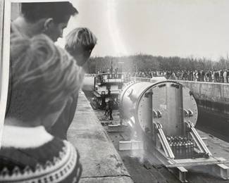 blk/white photo of reactor being transported to site