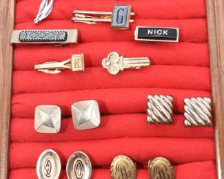 lot of various cufflinks and tie tacks