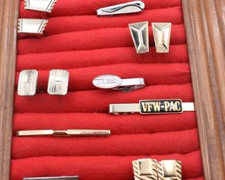 lot of various cufflinks and tie tacks