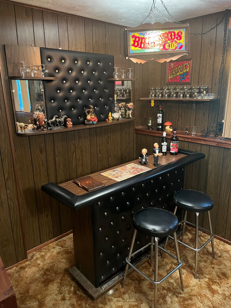 Portable bar with two matching barstools, hanging bar light, glass whiskey sign, bar paraphernalia and mirrors.
