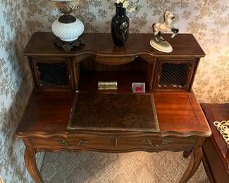 Victorian desk with milk glass lamp.