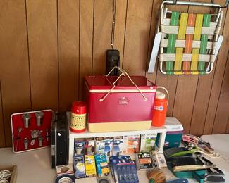 Vintage Colman, metal cooler, assorted tapes, assorted lightbulbs, and brushes.