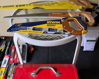 26” Thrifty crosscut saw, 18” Friskars tree branch saw, 13” Irwin marathon saw all in like new condition and displayed on a round deck table and a Bonney tool box.