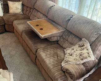 Sectional couch with recliners on both ends and drink tray.