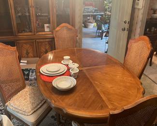 Dining room table with two leaves and six matching chairs.