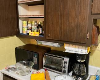 Microwave oven, toaster, oven, coffee maker and dishes.