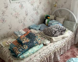 Single bed and linens.