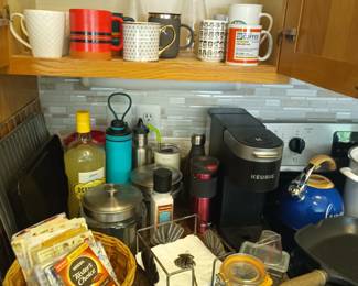 Mugs, water bottles and coffee maker