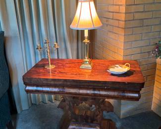 Absolutely gorgeous and unique game table from early 1900’s. The top flips open and you turn it to fit the base of the table. There’s a compartment to keep cards and games.
