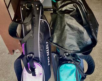 Two sets of golf clubs with bags