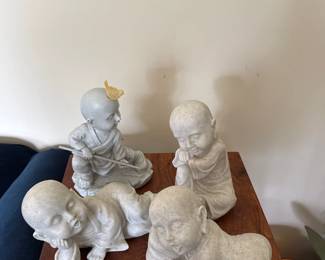 4 small concrete Buddha statues