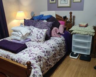 queen size bed with violet bedding 