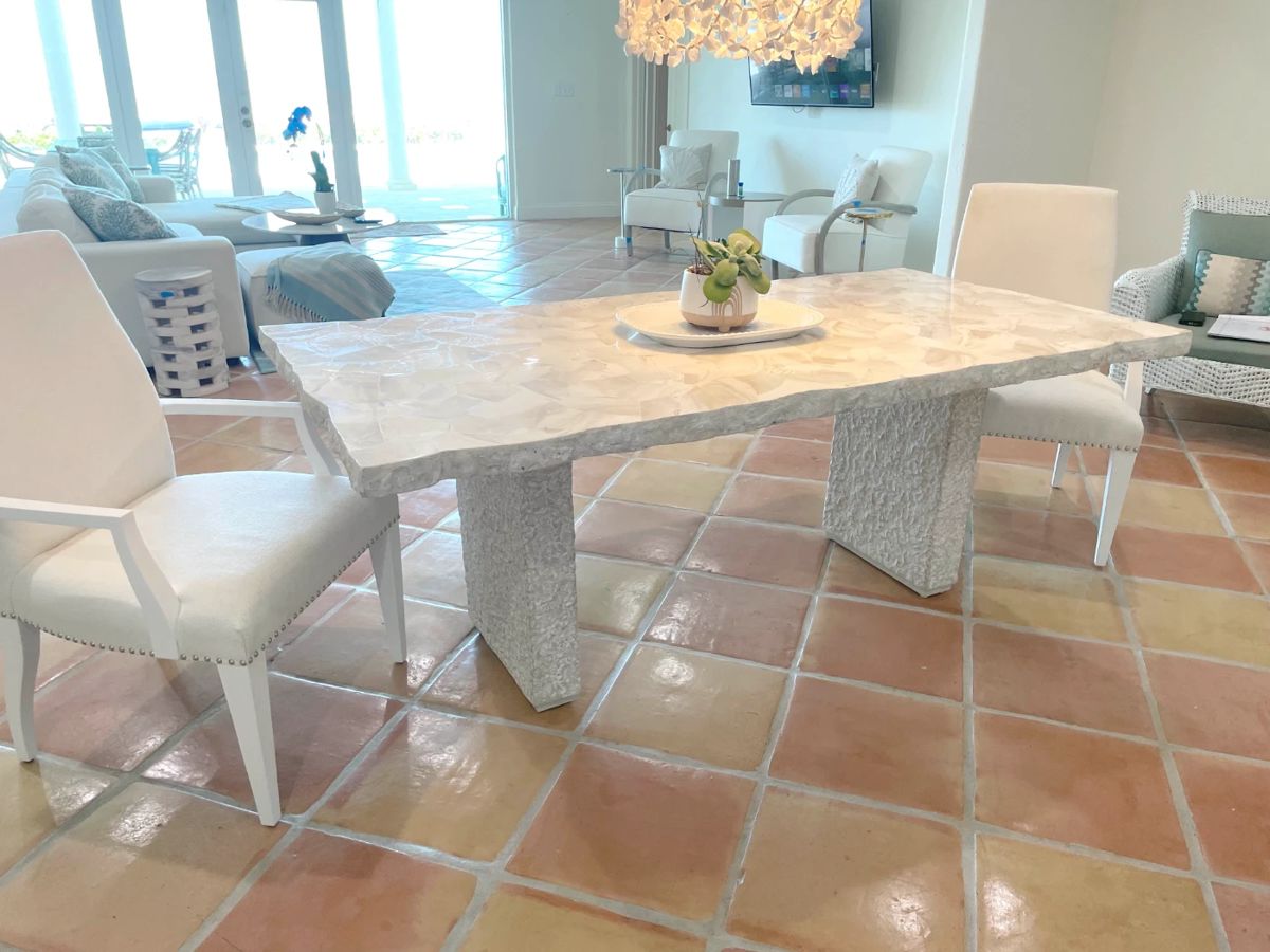 $3,200 Designer Palecek dining table, seats 6. (New, this table likely sold for $10,000+) This is from the Camilla Collection and features fossilized clam shale top with a natural edge, and a chiseled “stone” base. Piece separates into three pieces and weights a combined 286 lbs. Dining table comes with 6 chairs – (2) Lexington Home dining chairs with arms, (2) Arhouse traditional dining chairs, and (2) Arhouse high back padded chairs – all in off-white. Some upholstery marks.