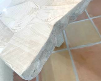 Camilla Collection and features fossilized clam shale top with a natural edge.
