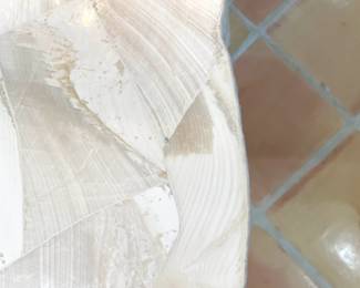 Camilla Collection and features fossilized clam shale top with a natural edge.