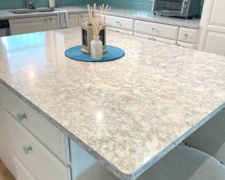 $600 OBO Kitchen island, 63”W x 45.5”D x 36”H including marble top – white with blue vein & “diamond” accent. Island box features six drawers and (1) double cabinet with roll out drawers.
