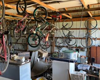 Many vintage and antique bicycles, there is another side of the barn behind that wall with many more items