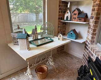 Table with wrought iron base, bird houses