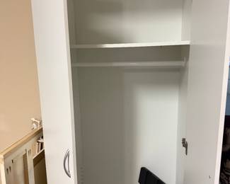 White storage cabinet with doors. 12 inches the garage. Some with drawers and some with racks