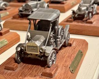 $28 each (12 different models available); Danbury Mint classic car models on wooden bases with brass plaque; 8x4x2