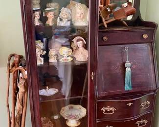 Vintage Cabinet fill with goodies. View Master with 3 cards, porcelain heads and more. Container full of handmade walking canes.