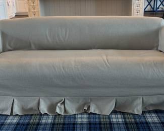 Crate & Barrel Crawford Slipcovered Sofa with Box-Pleated Skirt by Jake Arnold. Measures 86" W x 38" D. Photo 1 of 4.