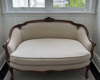 Antique Settee Upholstered in Neutral Fabric. Measures 48” W x 30” D. Photo 1 of 4.