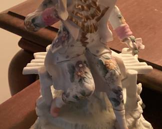 Figurine Lady Wearing Blue Hat Sitting on Bench