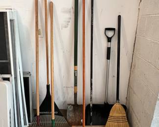 Assorted rakes, brooms, shovels.