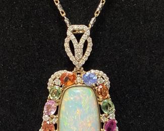 14KT YELLOW GOLD OPAL, SAPPHIRE, & DIAMOND PENDANT 18’’L CHAIN, 14.69cts OPAL, 5.8cts SAPPHIRE, 1.07cts DIAMONDS, 21.6g TOTAL WEIGHT, AIGL APPRAISAL $24,385.00