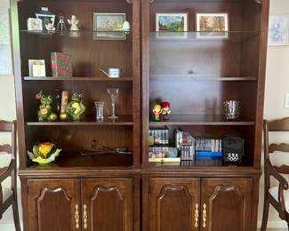 2 solid cherry lighted bookcases with 2 wood shelves and 1 glass shelf