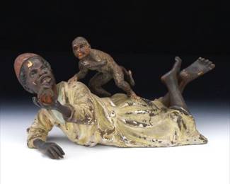 ColdPainted Vienna Bronze Figure of a Reclining Man with Monkey Austria, early 20th century