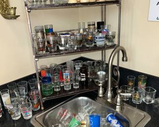 Large collection of shot glasses