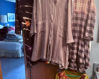 Walk in closet full of ladies clothing.