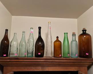 Antique glass bottles including P.E. Wills's Celebrated Wines, an 1890's L Rose & Co Ltd lime juice/cordial bottle, a Muskegon Bottling Works drugs or poison bottle, a vintage Clorox 16oz amber glass bottle, a Sanitary Bottling Works Kalamazoo Mich glass bottle