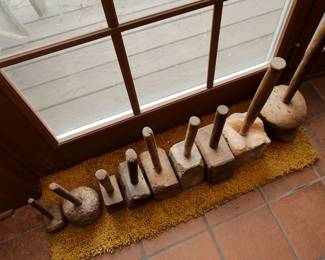 Closer view of the collection of primitive antique wooden mallets