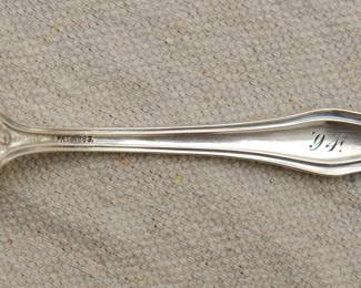 Closeup of the back of the beautiful antique late 19th century sterling silver spoons. Marked on back with sterling and "Pat. 1893" and engraved with '94; monogrammed on front reads "Ethel"