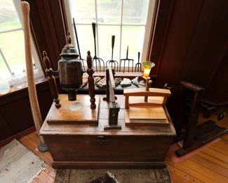 Vintage primitive hand-forged iron fishing spears, antique hand carved wooden keno goose, vintage wooden flower press, primitive wooden storage chest, antique opalescent glass light shade, glass flask bottles