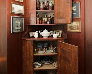 Open view of vintage two-part wooden corner cupboard