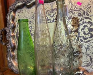 Antique glass bottles including P.E. Wills's Celebrated Wines, and an 1890's L Rose & Co Ltd lime juice/cordial bottle