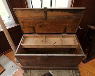 Open view of primitive wooden storage chest