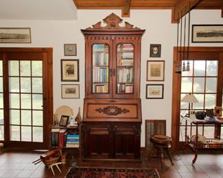 A classic 19th century secretary desk bookcase, framed antique photographs, antique American piano stool with glass ball feet, antique side table with lower shelf with galleried rim