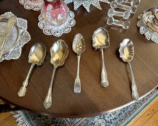 Sterling silver berry spoons including a circa 1895 Art Nouveau sterling silver Towle 'rustic' berry serving spoon; a glass bowl with silver rim, a sterling silver master butter knife, cut glass/crystal knife rests