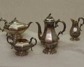 (Before cleaning) A 19th century English sterling silver teapot, coffee pot, creamer, and sugar bowl