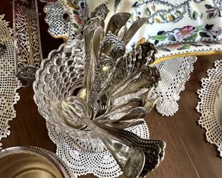 Closer view of collection of silver spoons in a 19th Century EAPG C. Adams & Company Glass Factory "thousand eye" clear glass spoon holder, along with an antique sterling silver sugar cube tray or cracker cradle