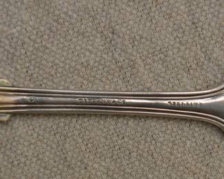 Closeup view of the back of the early 20th century Tiffany & Co. sterling silver forks, "Fiddle" pattern; monogrammed