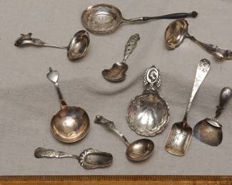(Before cleaning) A delightful collection of antique silver tea caddy spoons and tea strainers